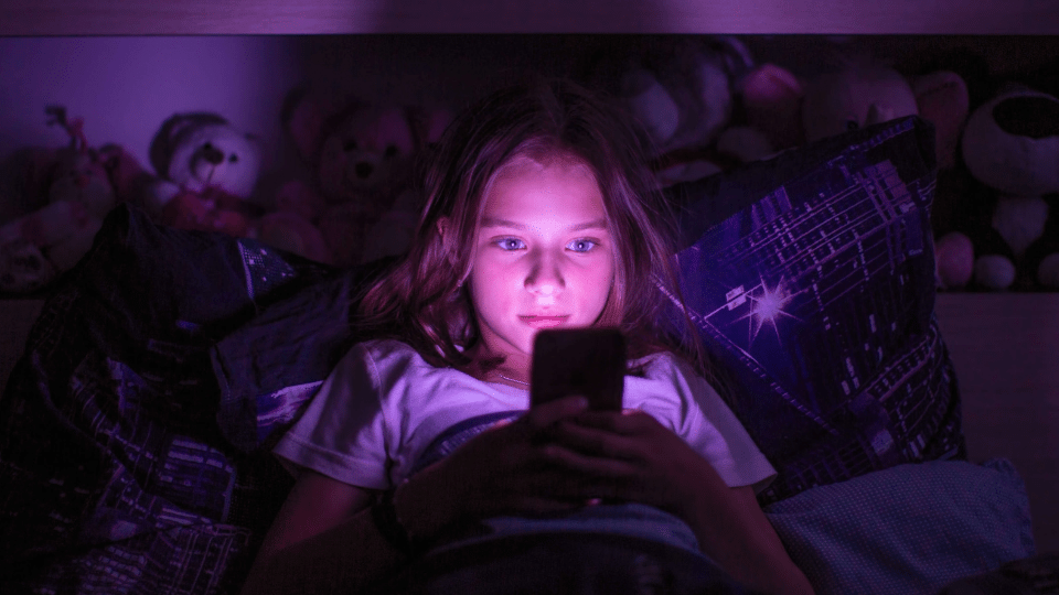 A child uses social media at home by themselves